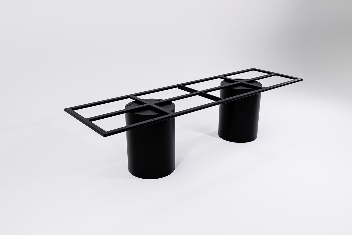 A black modular table base consisting of two cylindrical pedestal legs and a connecting frame.