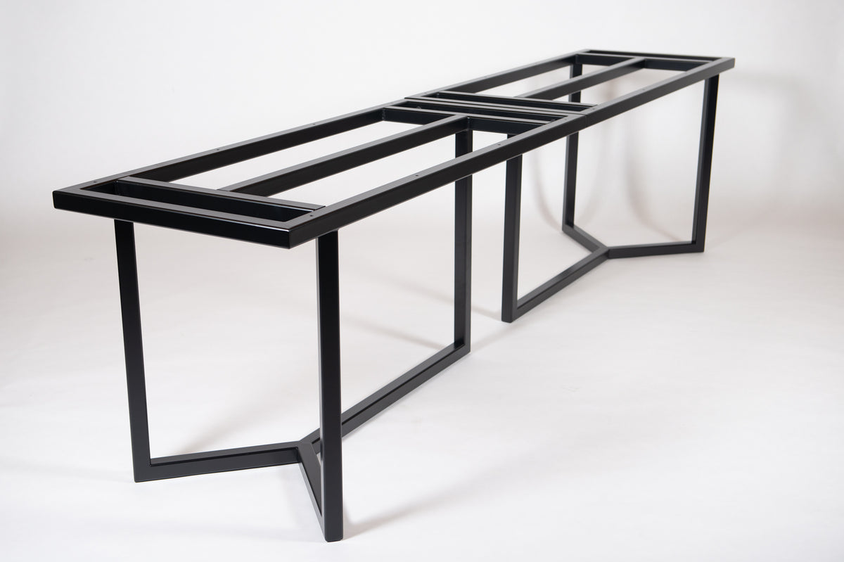 A heavy-duty black metal frame designed for forming large dining or conference tables.