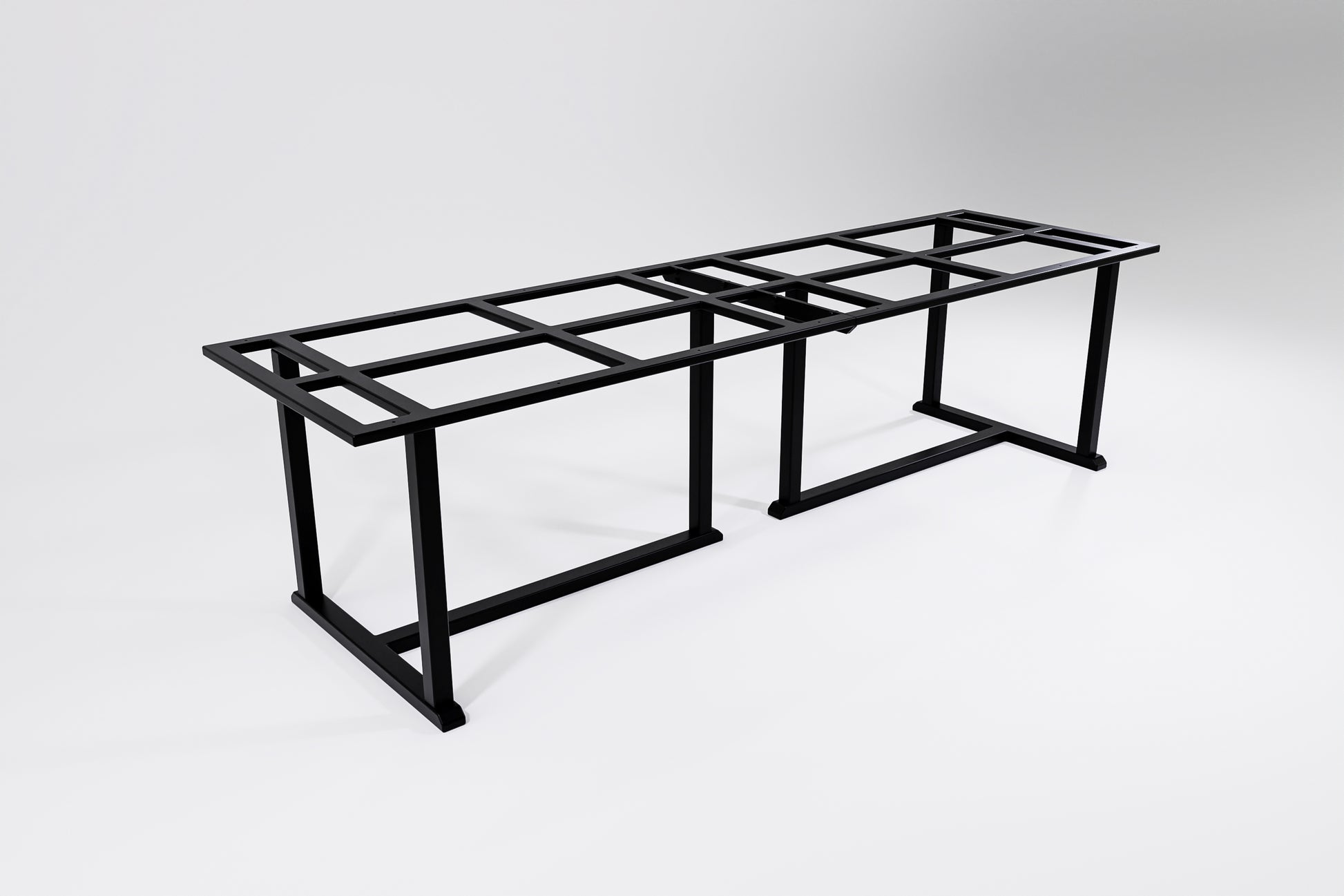 A long and wide metal table frame with traditional handcrafted details designed to hold a heavy stone top