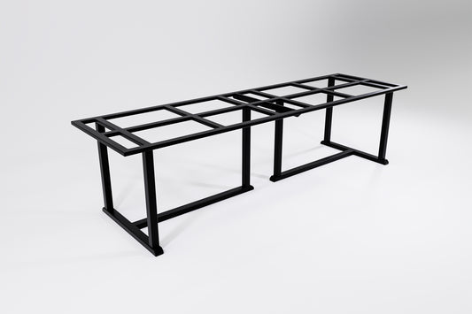 A long and wide metal table frame with traditional handcrafted details designed to hold a heavy stone top