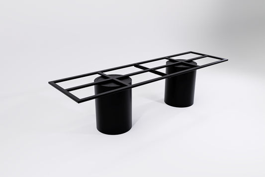 A black modular table base consisting of two cylindrical pedestal legs and a connecting frame.