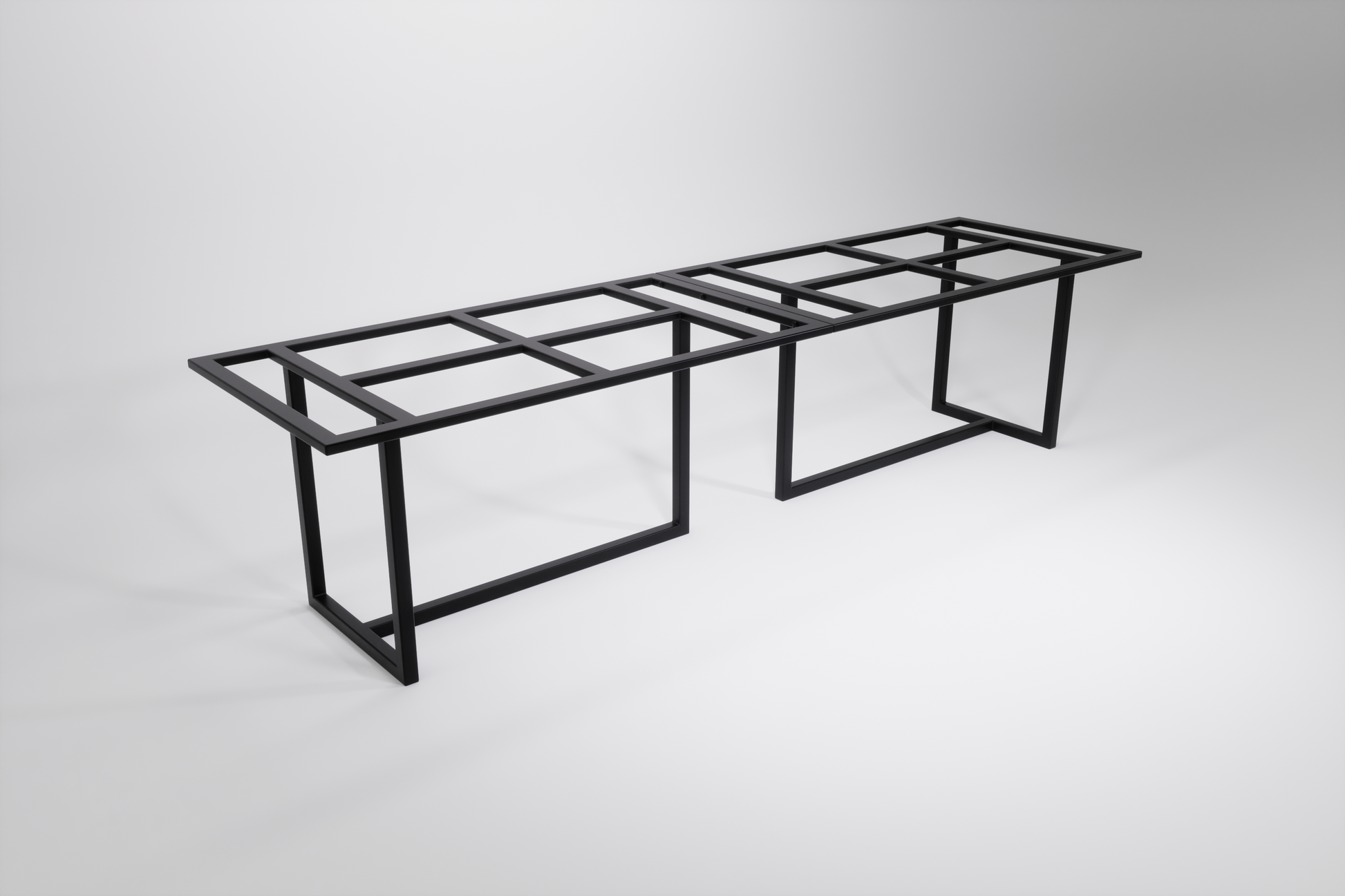 A black modular heavy-duty table base designed to be bolted together, consisting of two sections that form a long table base with multiple legs.