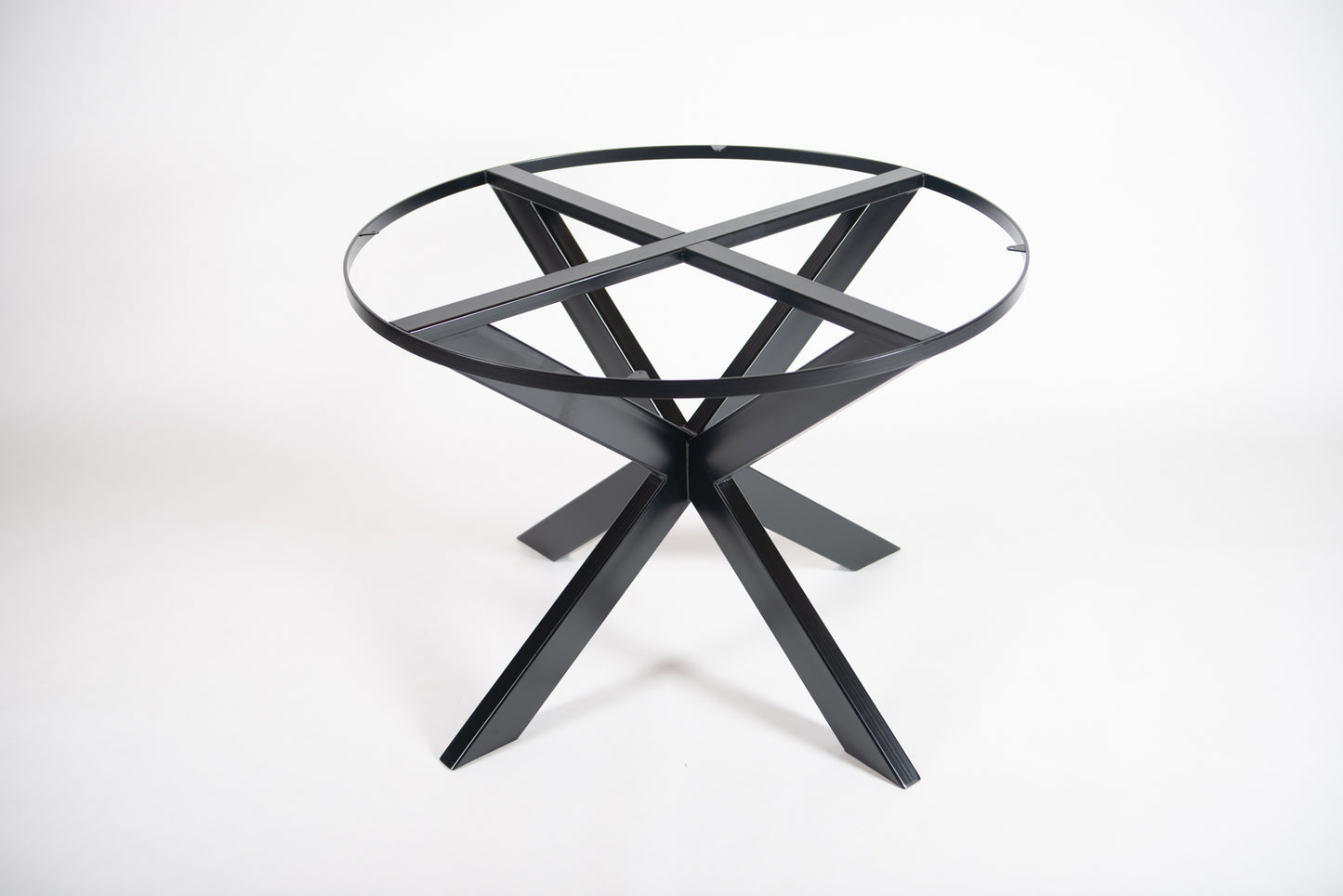 A black metal table base with a circular shape designed to support a stone tabletop.